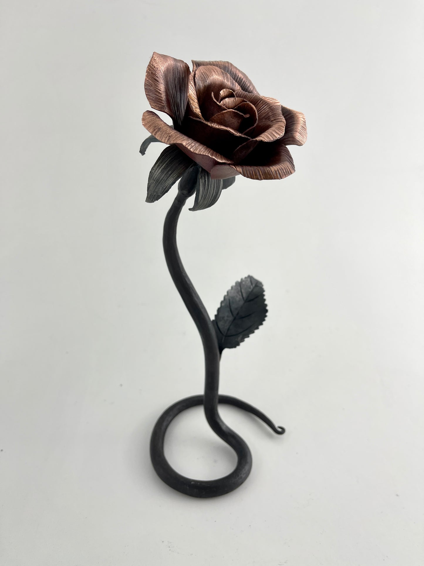 Copper and steel rose with scrolled base